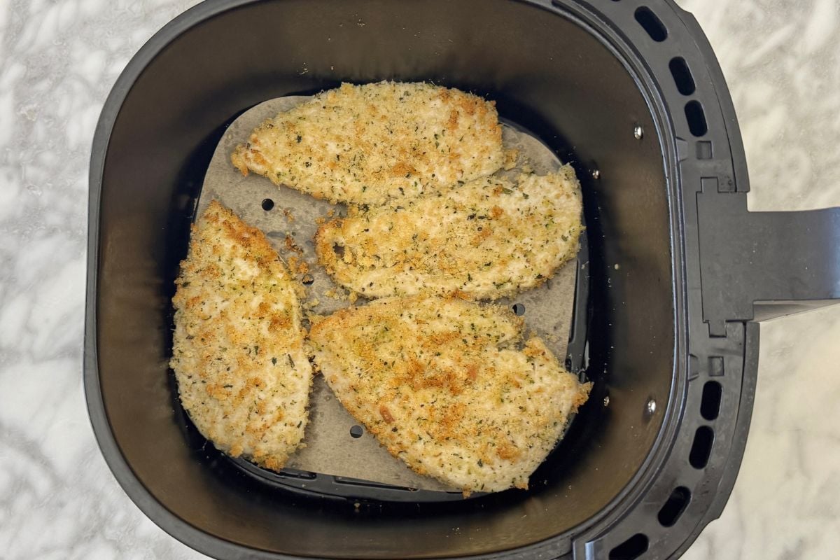 Air fried breaded chicken in air fryer basket