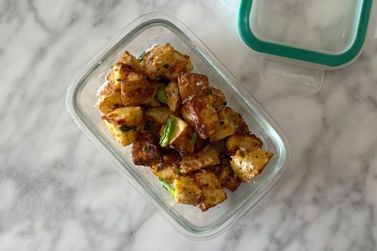 Air fryer parmesan potatoes in container