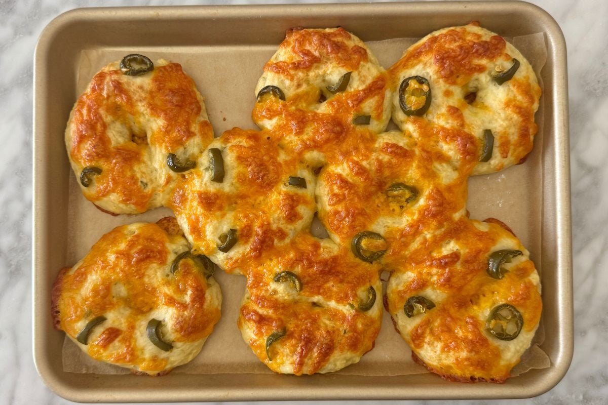 Baked cottage cheese jalapeño cheddar bagels on baking sheet