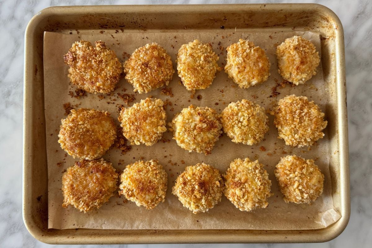 Baked homemade chicken nuggets on a sheet pan