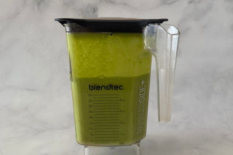 Blended green protein smoothie in blender