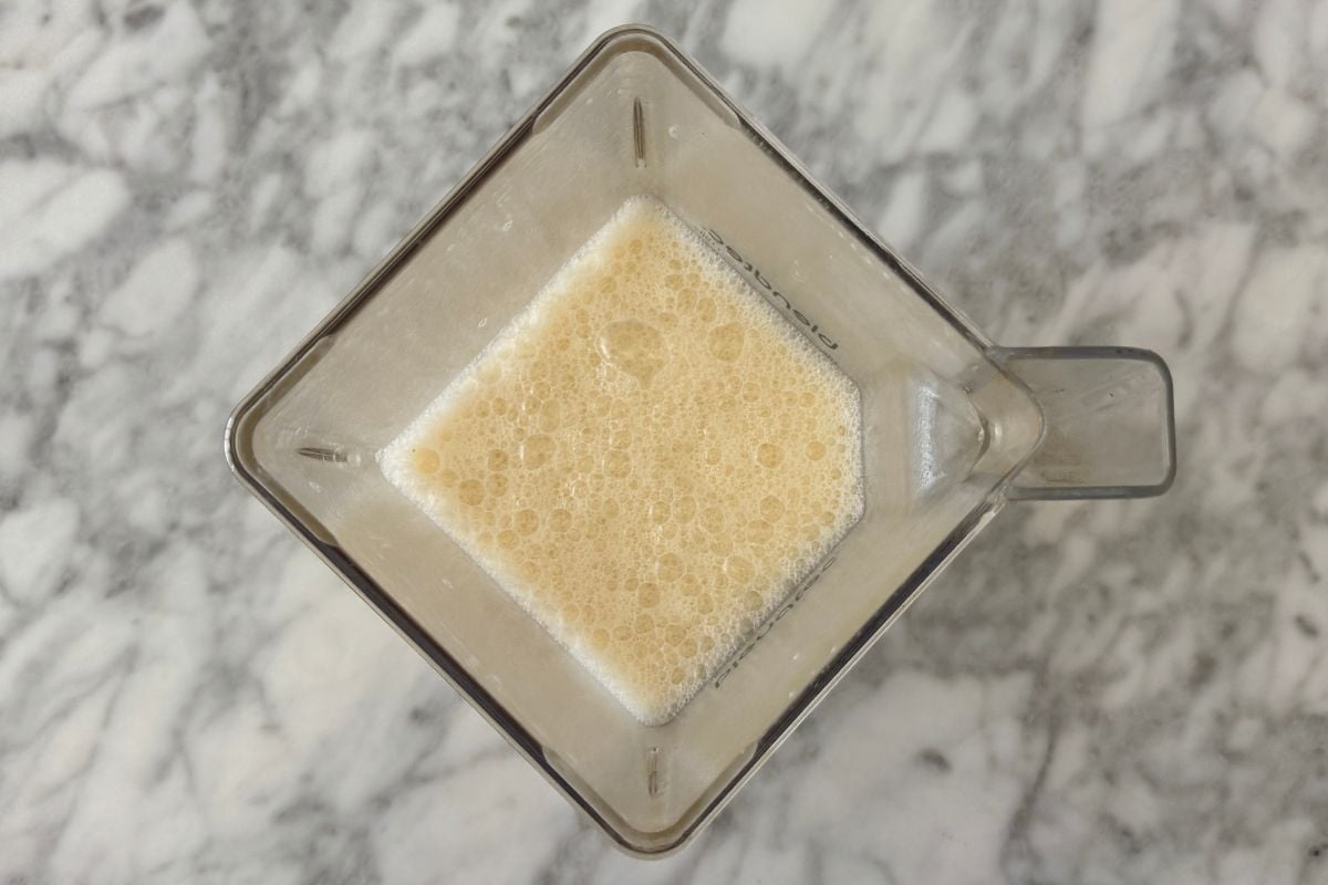 Blended healthy Orange Julius smoothie in blender