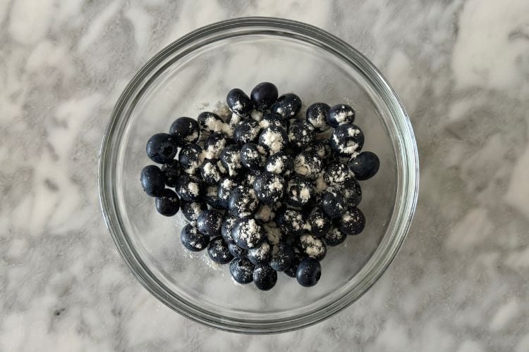 Blueberries in bowl with flour