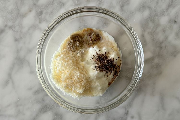 Caesar dressing ingredients in bowl