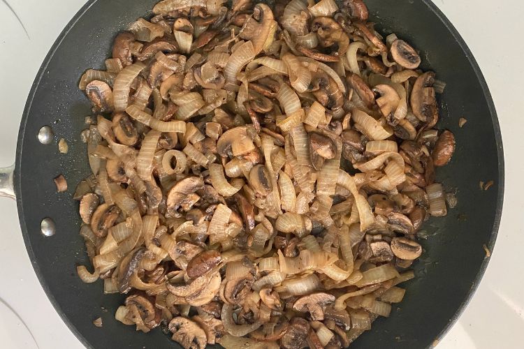 Caramelized onions and mushrooms in a pan