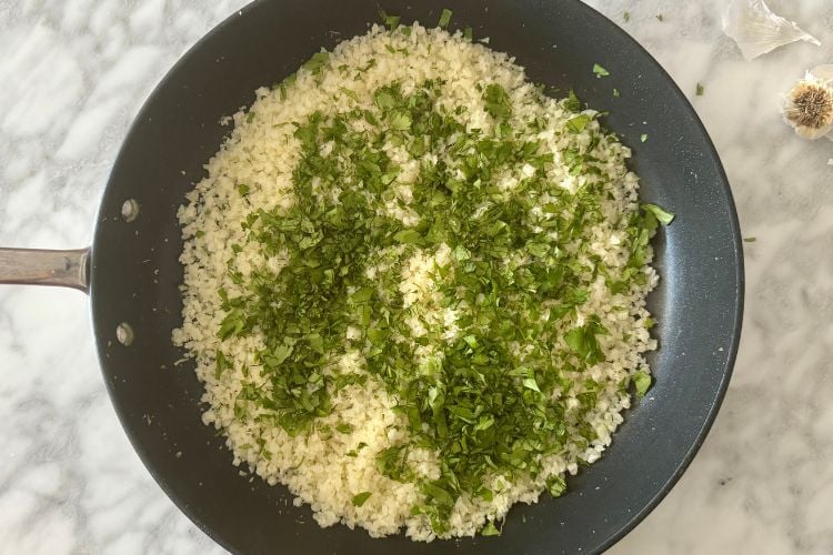 Cauliflower rice with cilantro and lime in pan