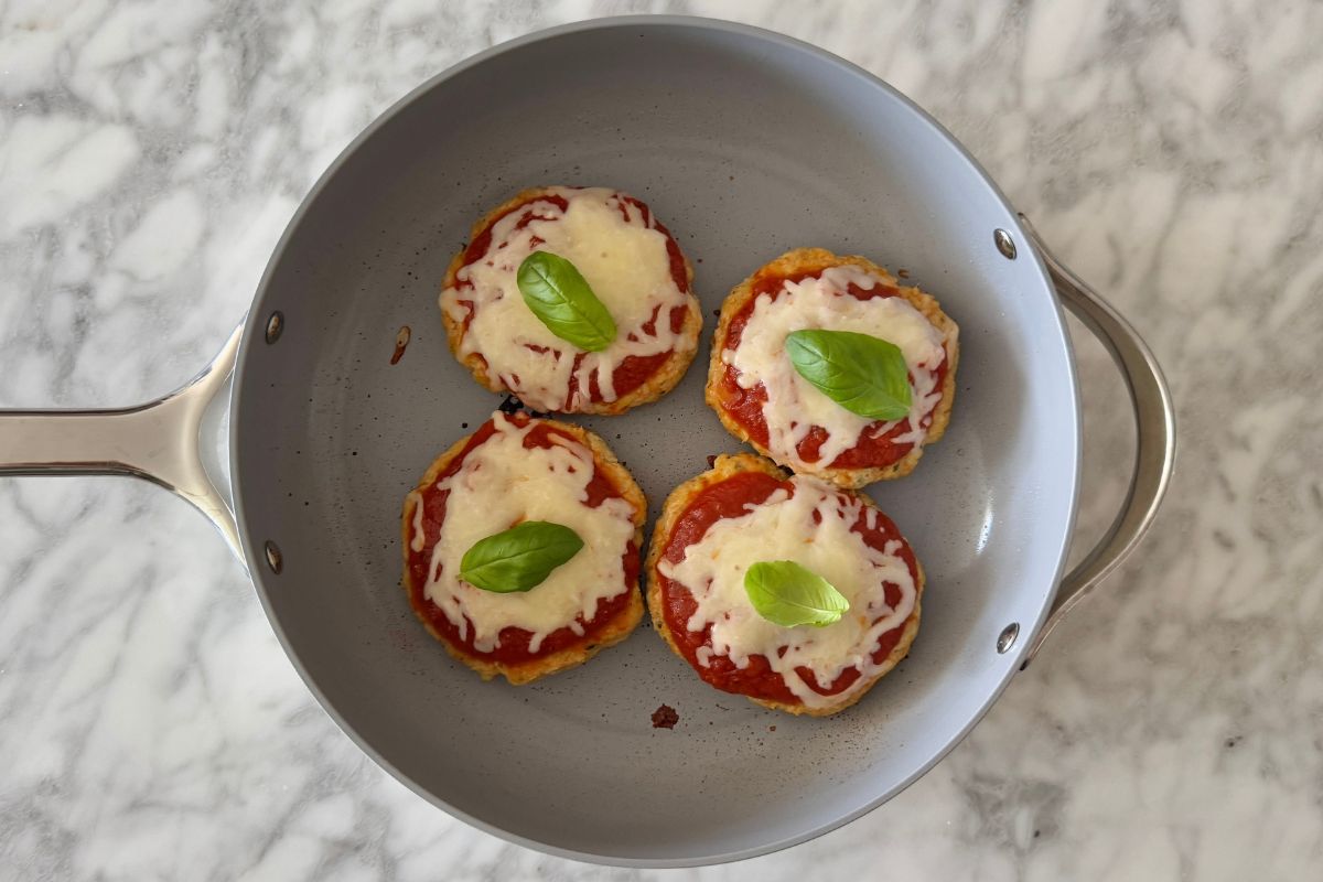 Chicken parmesan burger patties topped with basil