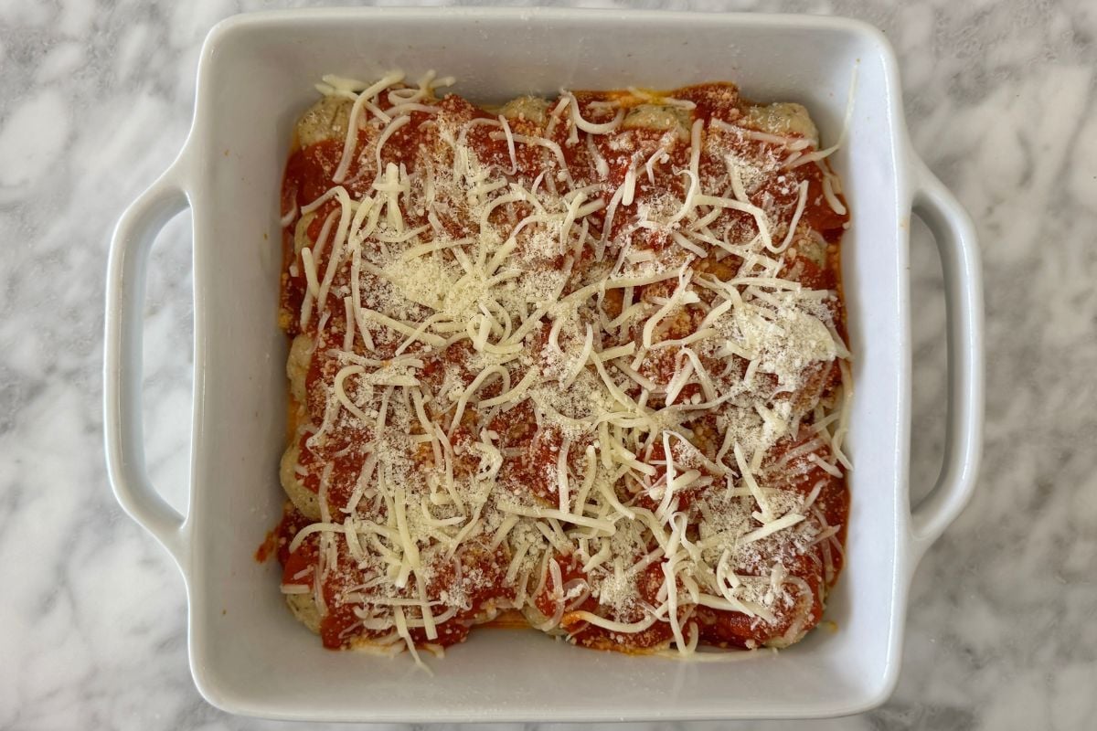 Chicken parmesan meatballs in baking dish
