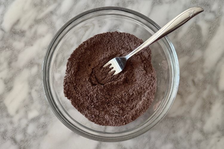 Chocolate protein mug cake ingredients mixed in bowl