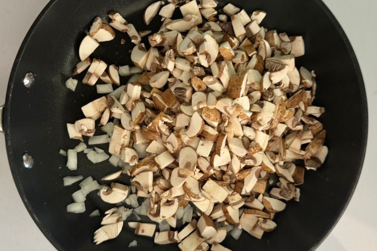 Chopped cremini mushrooms in skillet