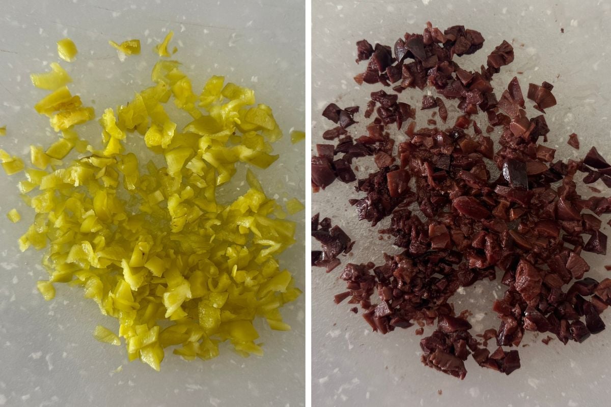 Chopped pepperoncini and olives on cutting board