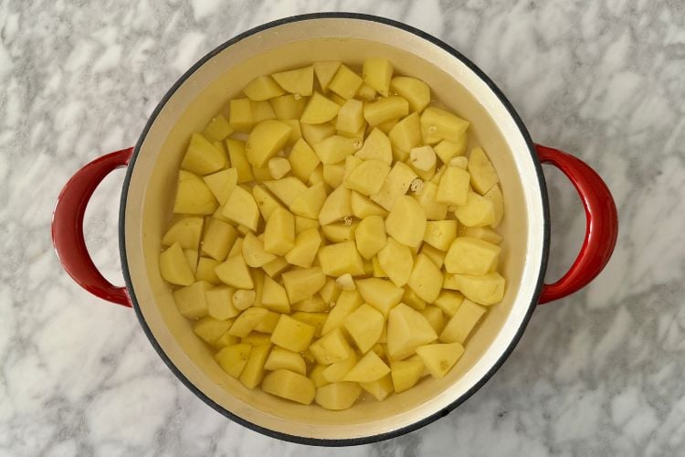 Chopped potatoes and garlic in Dutch oven