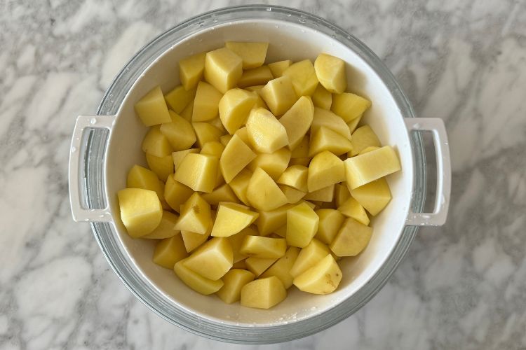 Chopped potatoes in strainer