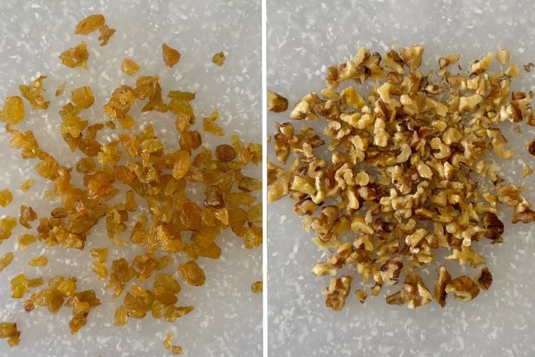 Chopped raisins and walnuts on cutting board