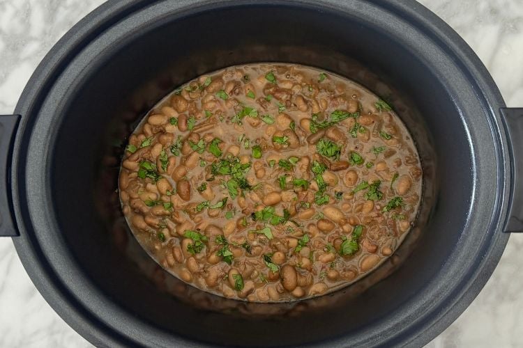 Cilantro over charro beans in slow cooker