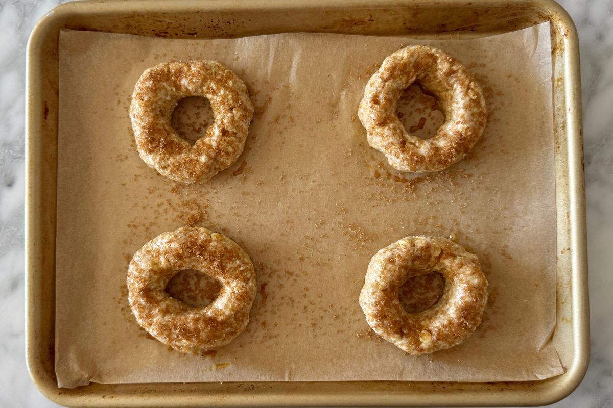 Cinnamon crunch protein bagels on sheet pan with topping