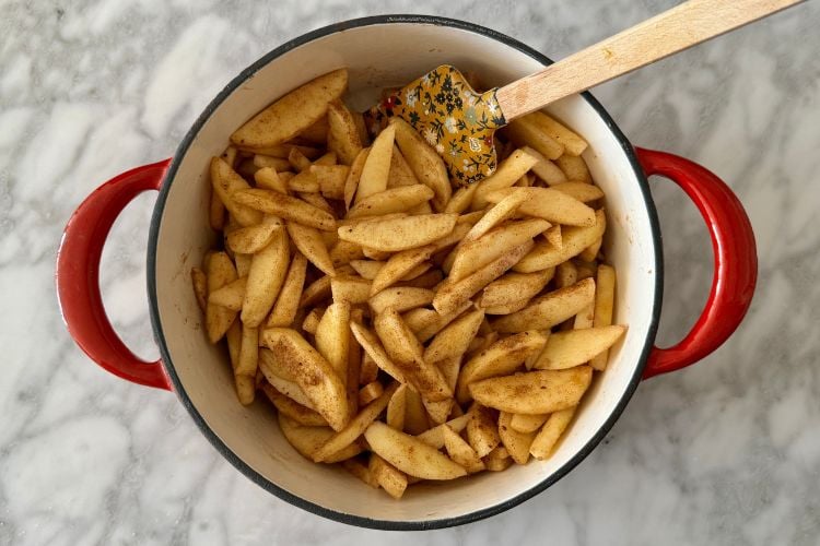 Coated apple slices in Dutch oven