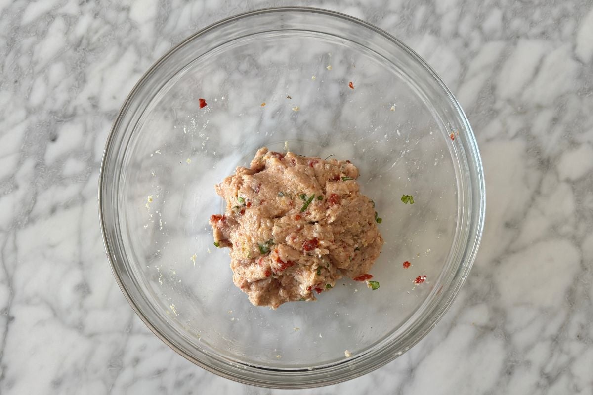 Combined marry me chicken meatballs mixture in bowl