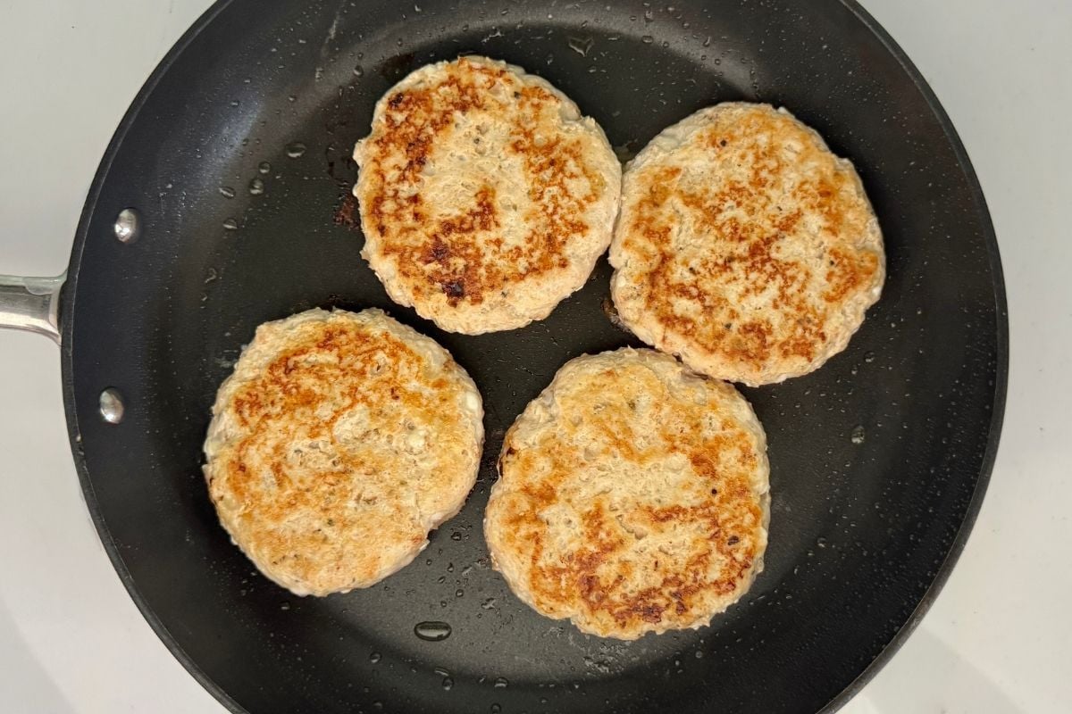 Cooked cottage cheese turkey burgers in pan