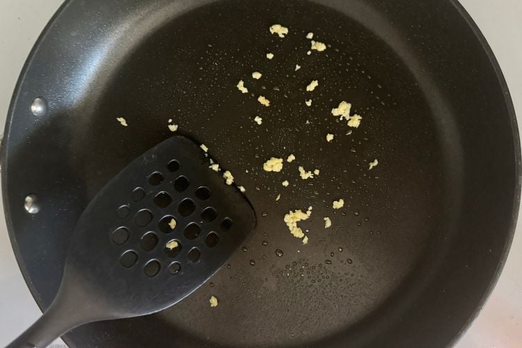 Cooked crushed garlic in pan