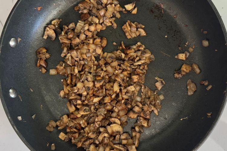 Cooked mushrooms and onions in skillet
