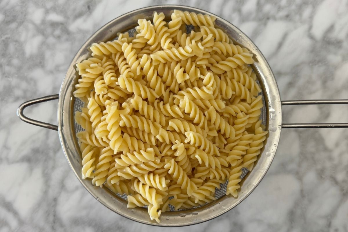 Cooked pasta for pasta salad in strainer