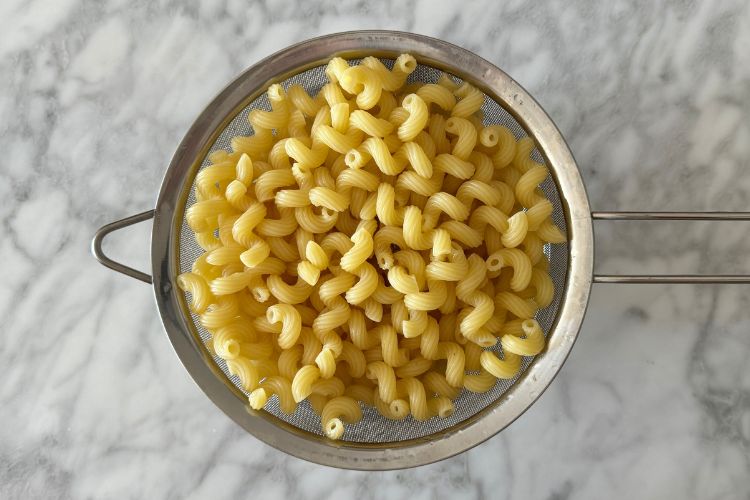 Cooked pasta in a strainer