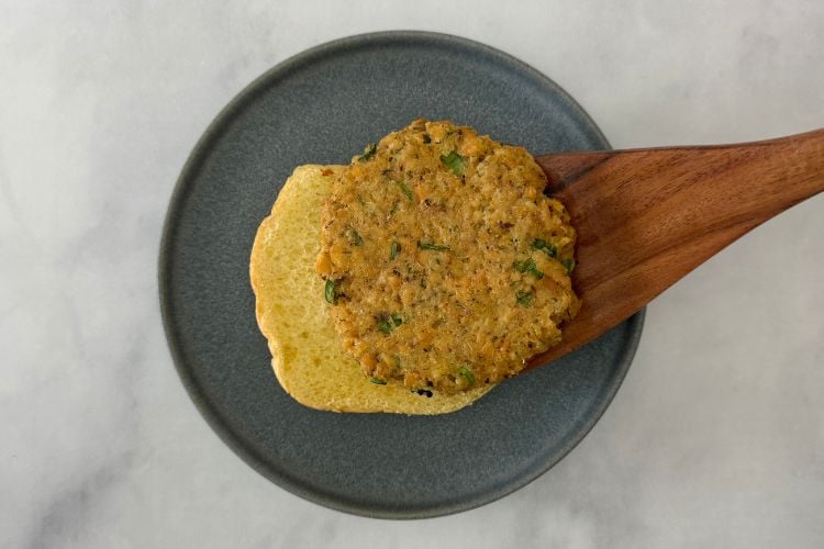 Cooked salmon patty on burger bun