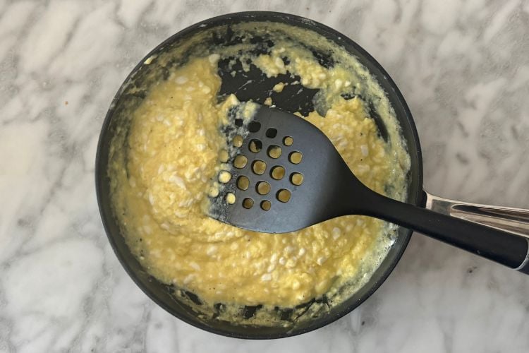 Cooked scrambled eggs with cottage cheese in skillet