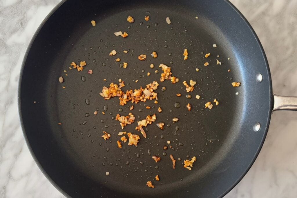 Cooked shallots and garlic in a skillet