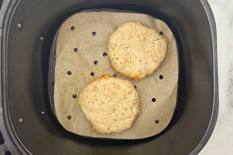 Cooked turkey patties in air fryer basket