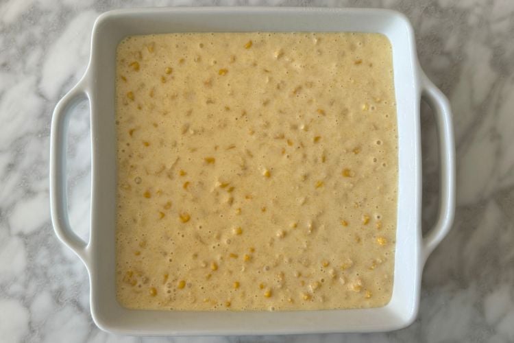 Corn casserole batter in a casserole dish