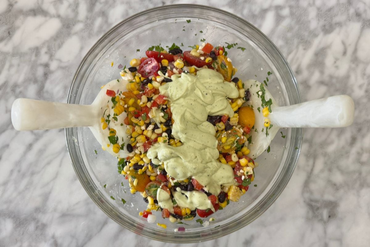 Corn salad with dressing in bowl