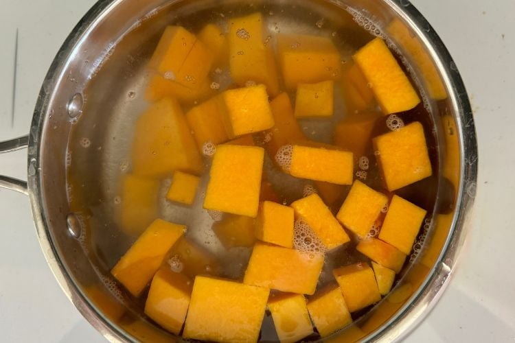 Cubed butternut squash in a saucepan