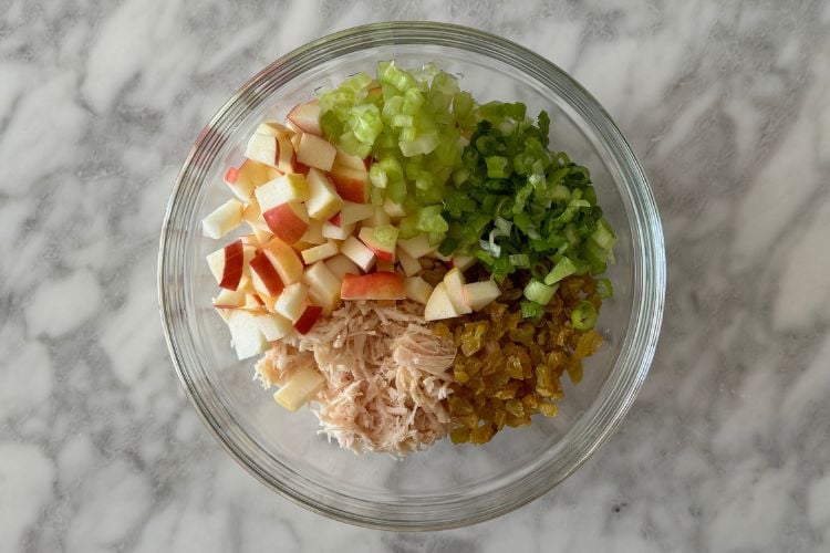 Curry chicken salad ingredients in bowl