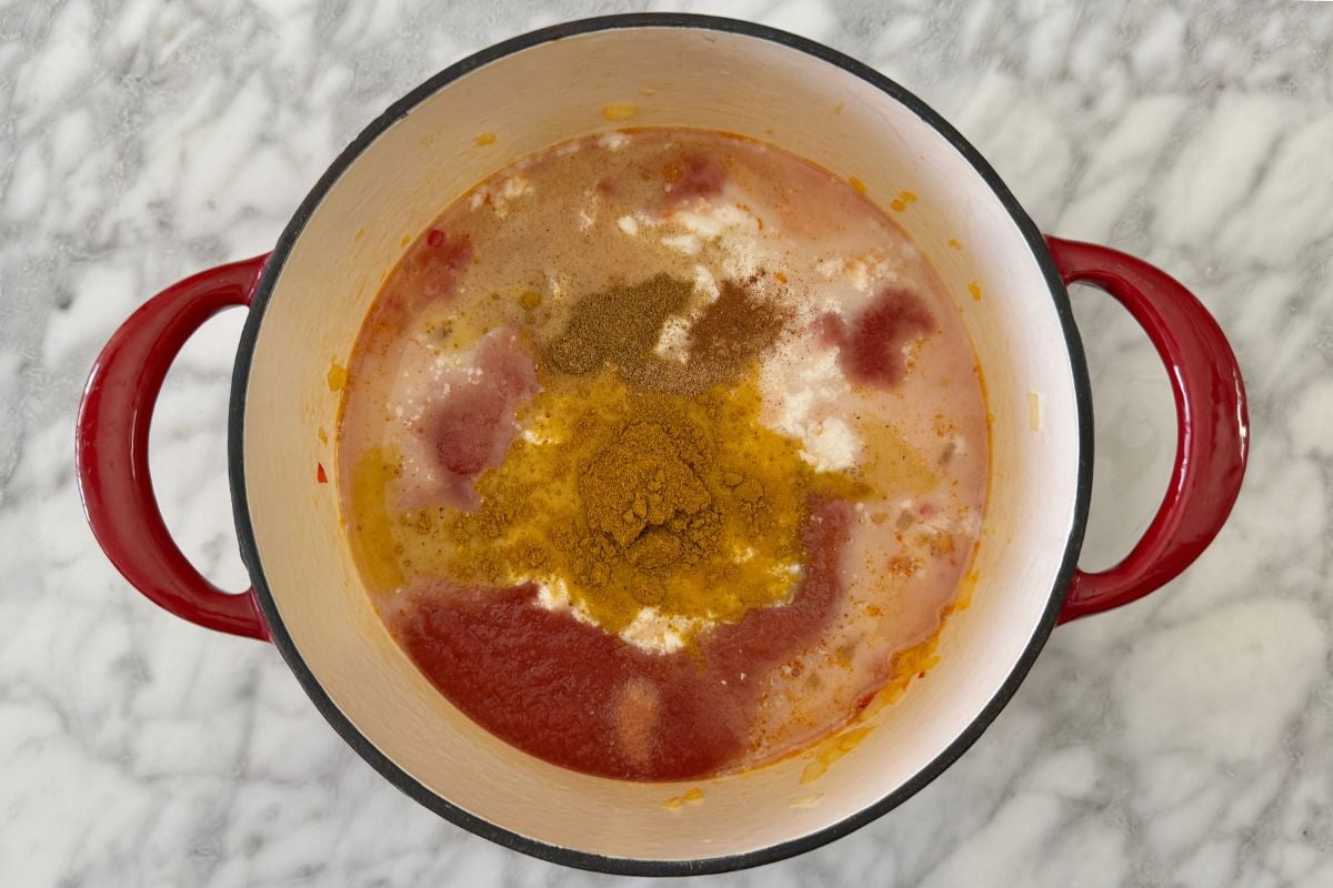 Curry powder and coconut milk in Dutch oven