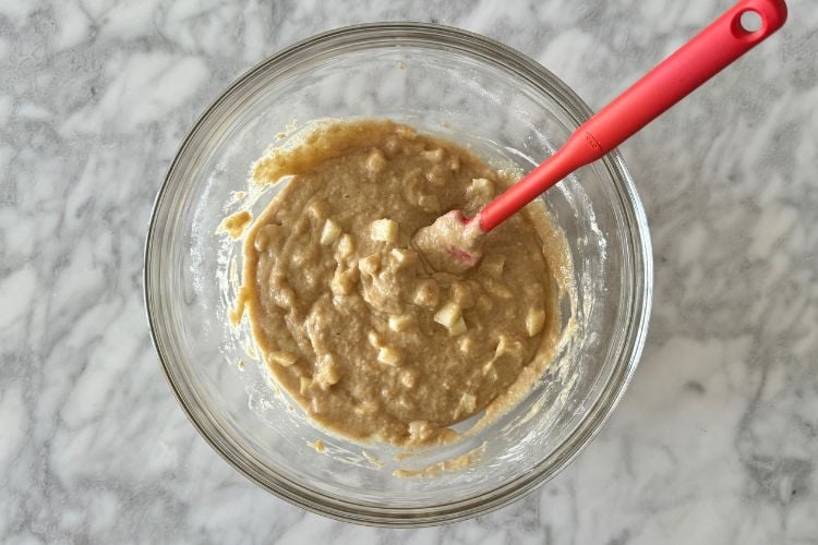 Diced apples folded into the batter