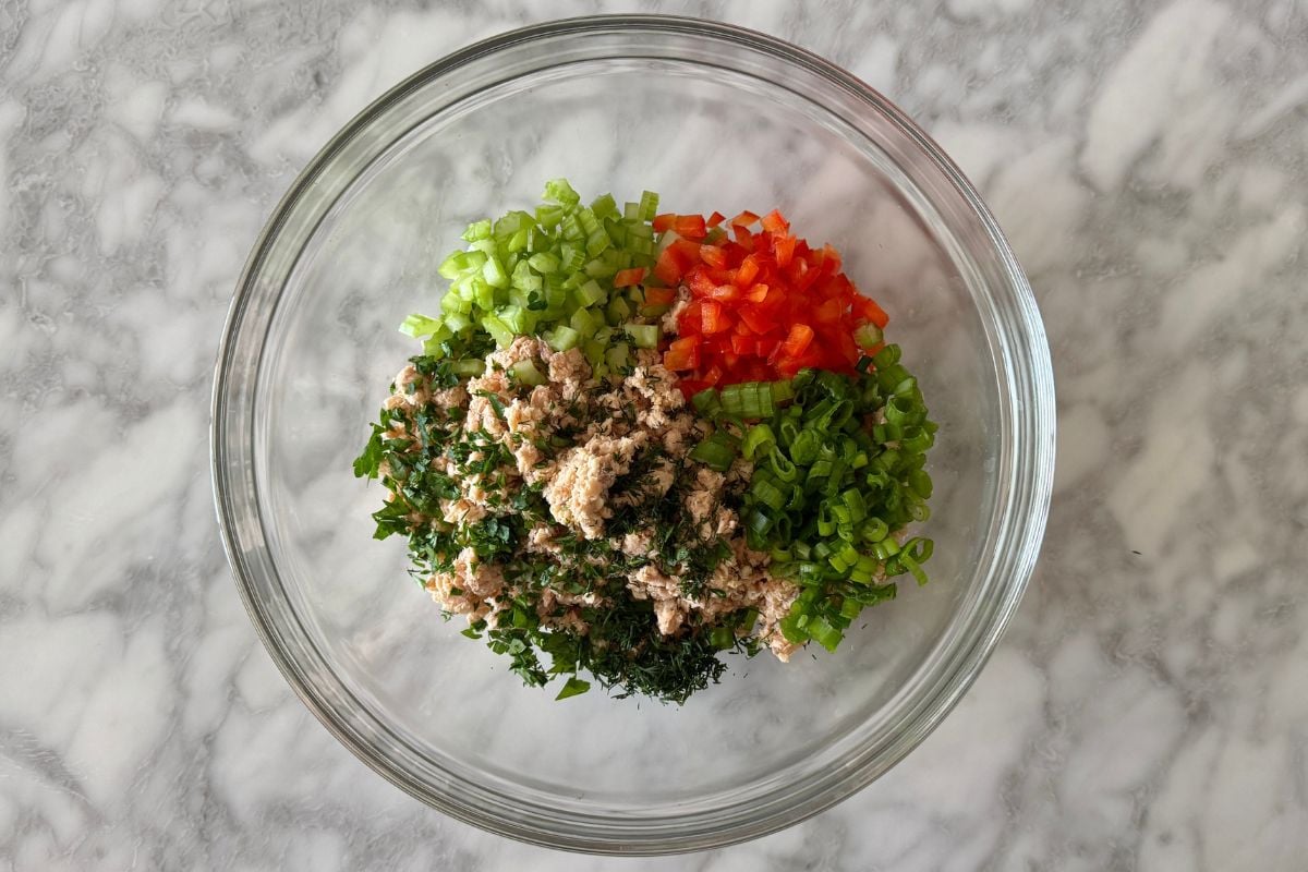 Drained canned salmon and veggies in bowl