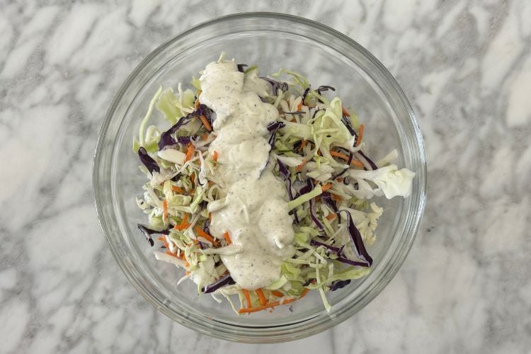 Dressing in bowl with coleslaw mix