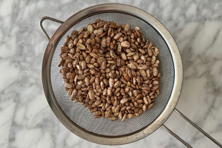 Dried pinto beans in strainer
