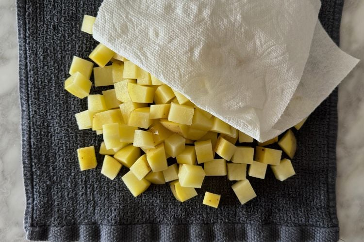 Dry diced potatoes with paper towel