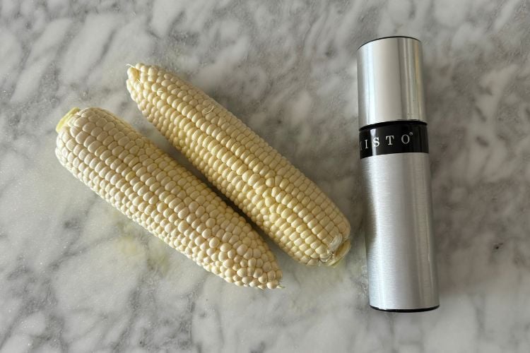 Ears of corn with olive oil spray