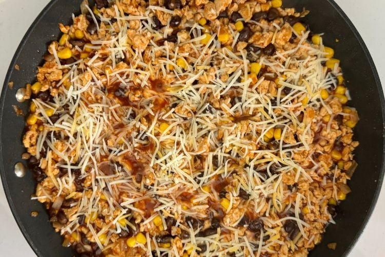 Enchilada skillet topped with cheese