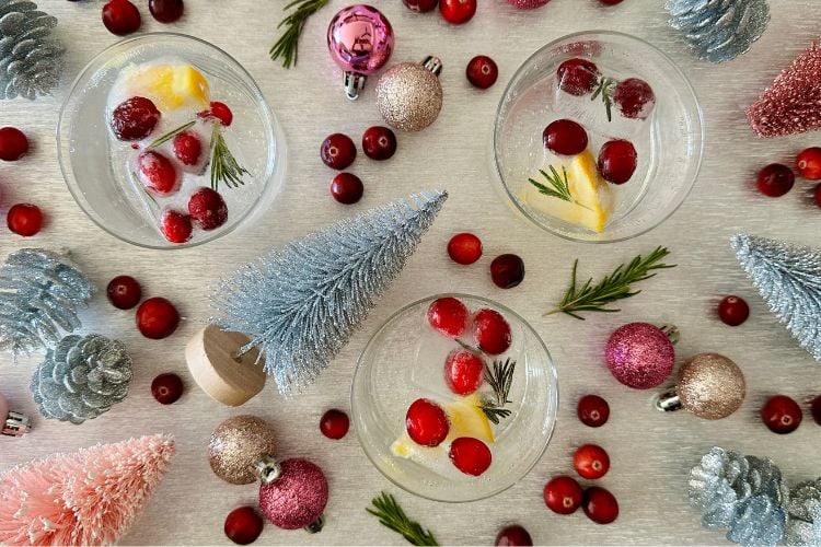 Festive ice cubes in cup with water
