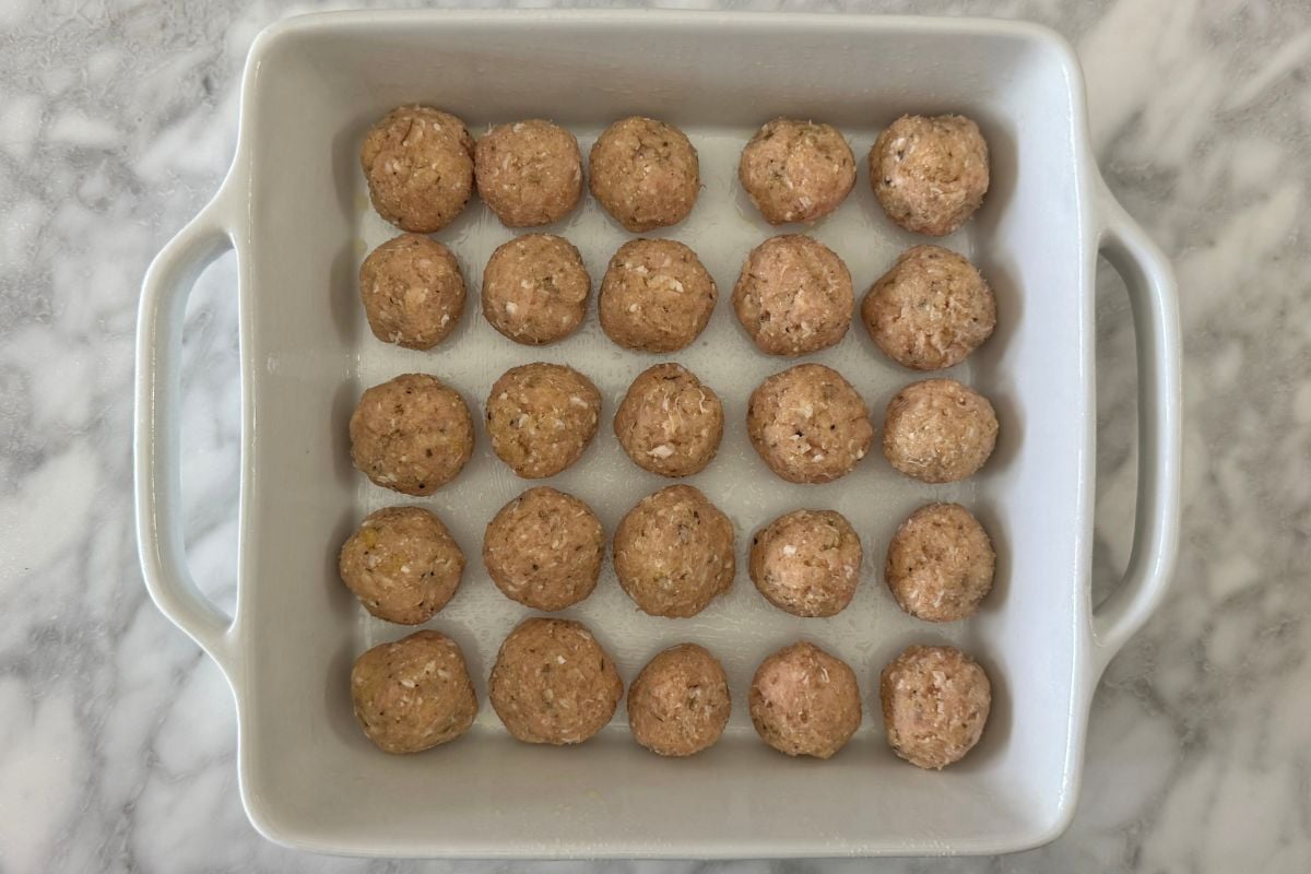 Formed chicken parmesan meatballs in baking dish