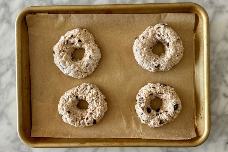 Formed cinnamon raisin bagels on a baking sheet