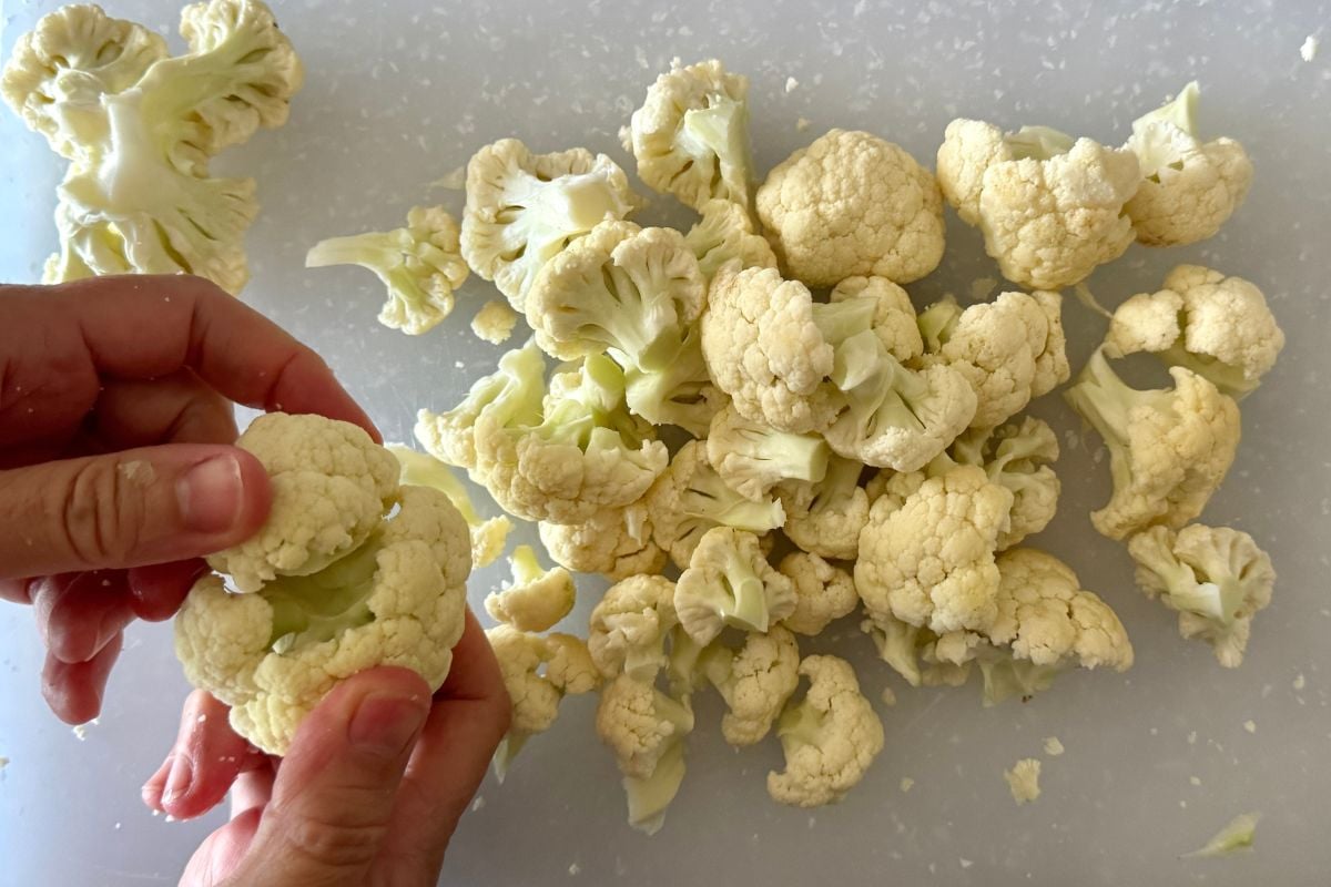 Fresh cauliflower florets on cutting board