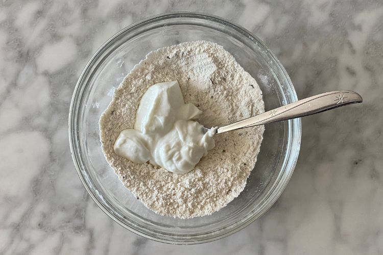Greek yogurt and self rising flour in bowl