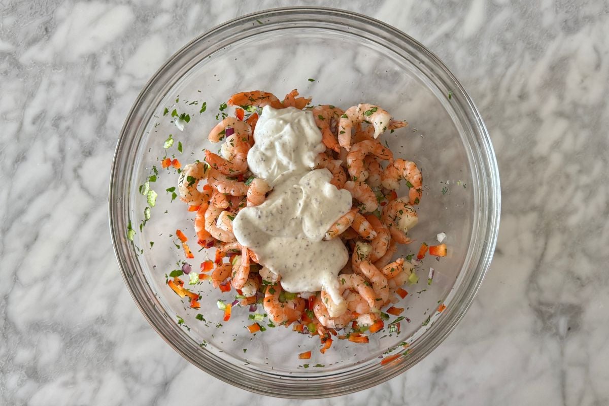 Greek yogurt dressing in bowl with shrimp salad