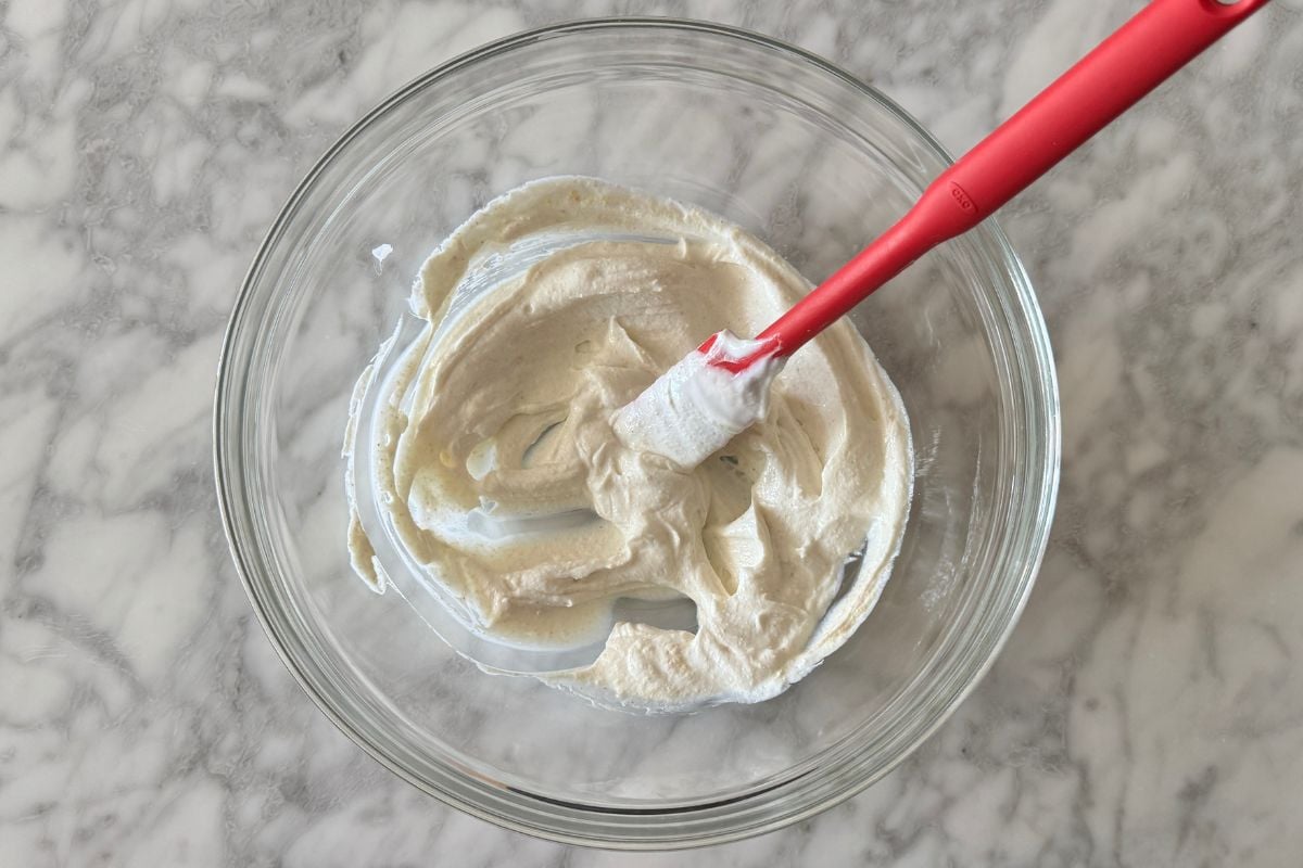 Greek yogurt in a large bowl mixed with garlic and onion powder